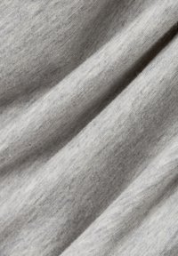 Light gray, textured fabric with subtle variations in color, displaying a soft, woven appearance and gentle draping.