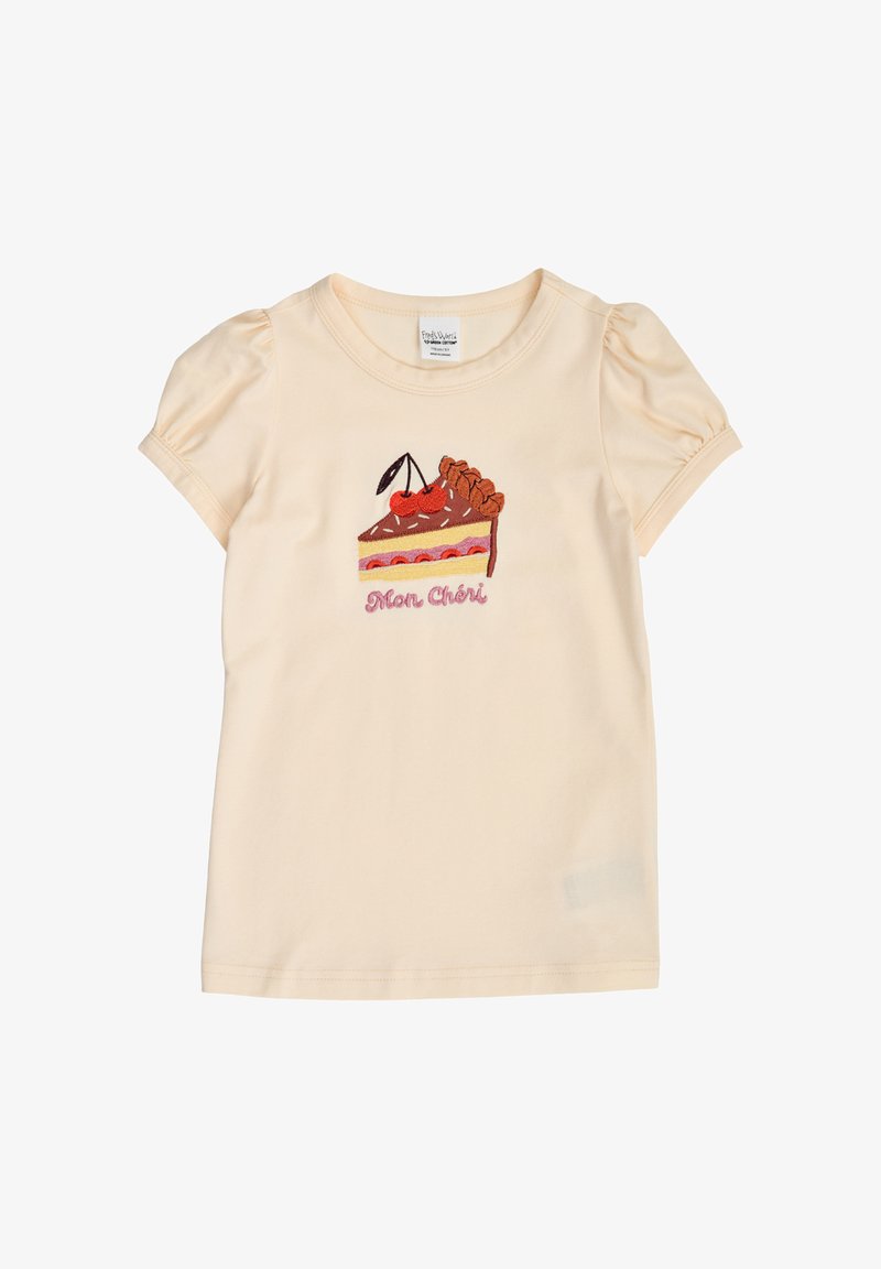 Chemise crème à manches courtes pour fille avec manches bouffantes, brodée d'un gâteau surmonté d'une cerise et le texte «Mon Chéri» en dessous.