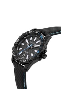 Reloj deportivo negro con una esfera texturizada, acentos azules y una correa de goma. Presenta marcadores de hora en negrita y una ventana de fecha. Diseño resistente al agua.
