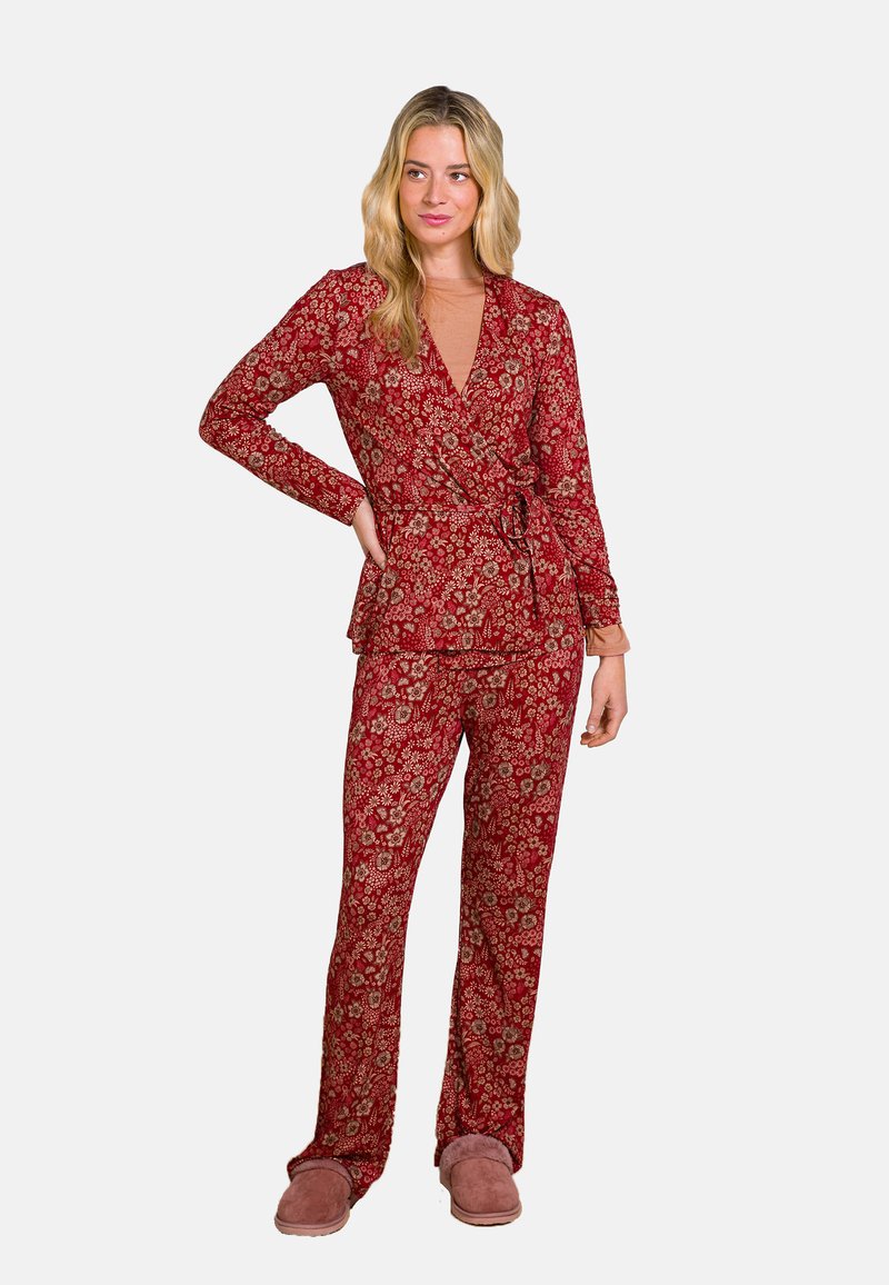 Roter Blumenpyjama bestehend aus einem Wickeloberteil mit langen Ärmeln und einem Bindeband in der Taille, kombiniert mit lockeren Hosen. Weicher Stoff, für besonderen Komfort entworfen.