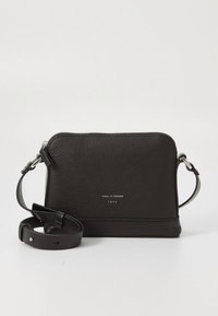 Black leather crossbody bag with textured surface, silver hardware, and a detachable strap. Features a zip closure and branded detail.
