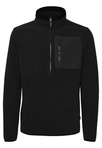 Svart fleece genser med høy krage, halv glidelås og en frontlomme med glidelås. Glatt, varm tekstur.