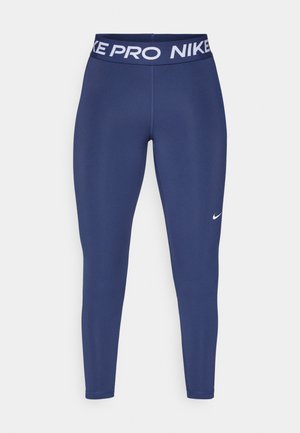 Leggings bleu marine en matériau extensible, avec une taille blanche "NIKE PRO" et un petit logo Nike blanc sur la jambe gauche.