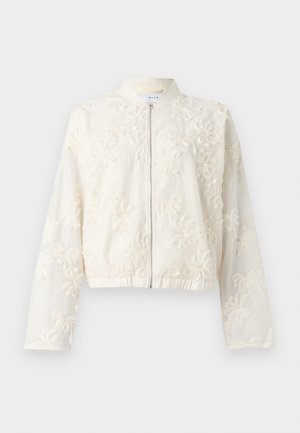Veste bomber blanche brodée avec fermeture éclair à l'avant, ourlet élastique et manches longues. Des motifs floraux ornent le tissu léger.