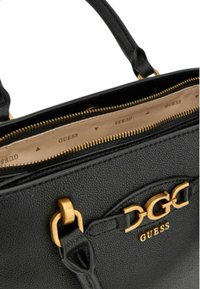 Borsa in pelle nera con accessori in oro, chiusura con zip e foderatura interna in tessuto brandizzato con motivi triangolari.