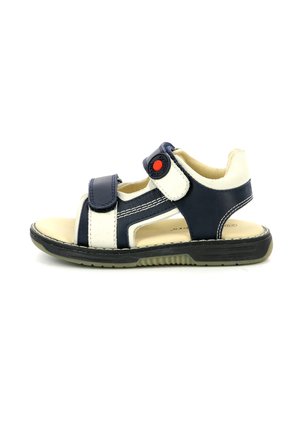 Sandalo per bambini blu navy e crema con due cinturini in velcro regolabili, suola in gomma e un bottone rosso di accento sul cinturino.