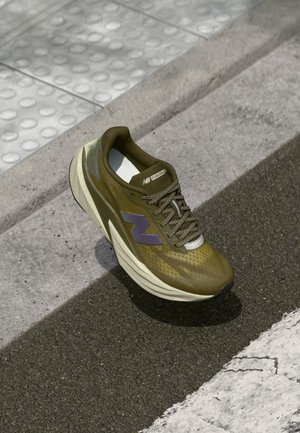 Olive green athletic shoe with a breathable upper mesh, cushioning midsole, purple logo accent, and textured rubber outsole for grip.