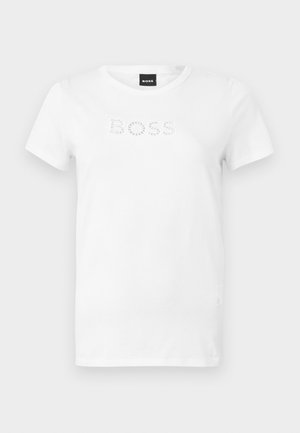 Biała koszulka z krótkim rękawem i okrągłym dekoltem, z napisem "BOSS" wykonanym z małych okrągłych wzorów na klatce piersiowej, pokazana na jednolitym tle.