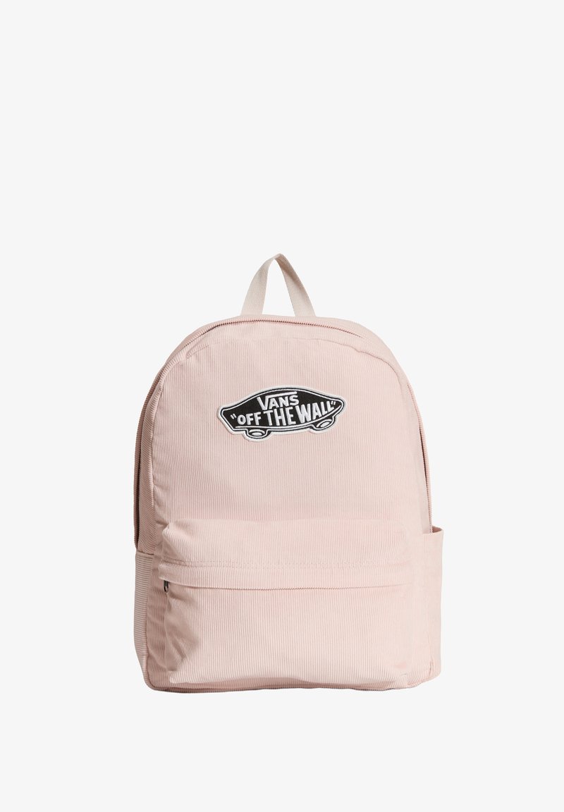 Mochila de pana rosa con un bolsillo frontal con cremallera, que presenta un logo de Vans en blanco y negro. Asa de tela marrón en la parte superior para llevarla.