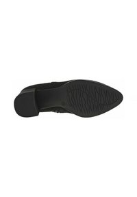 Semelle de chaussure en suede noir avec un léger talon, présentant un fond en caoutchouc texturé pour une meilleure adhérence et un contour lisse autour des orteils.