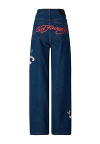 Wide-leg blue denim jeans featuring red "Ed Hardy" logo on the back, embroidered designs on both side pockets, and classic denim stitching.
