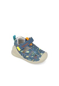 Lasten siniset tennarit, joissa on teksturoitu, kuvioitu kangas; sisältää keltaisia ja oransseja yksityiskohtia, tarranauhan ja kumipohjan.