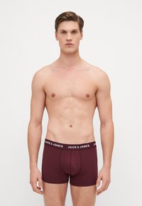 Burgunderfarbene Boxer Shorts aus weichem Stoff, mit einem enganliegenden Design und elastischem Bund, versehen mit dem "JACK & JONES" Logo in Weiß.