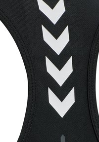 Black sports garment with a textured fabric, featuring a white chevron pattern and sleek lines along the neckline and armholes.