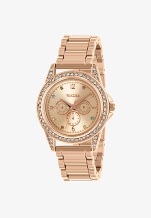 Montre-bracelet en or rose avec lunette ornée de cristaux, bracelet à maillons et trois sous-cadrans sur le cadran brillant ton or avec de petites marques colorées.