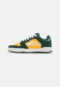 Low-top sneaker with green suede overlays, yellow leather panels, white logo and laces, and a white sole on a plain white background.