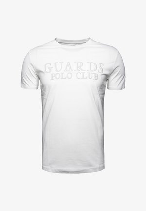 Valkoinen puuvillainen t-paita, jossa on lyhyet hihat ja pyöreä pääntie, ja jonka etuosassa on hailakka harmaa "GUARDS POLO CLUB" -teksti.