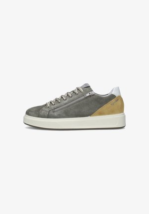 Scarpa da ginnastica bassa in suede grigio con toppa beige sul tallone, suola bianca, cerniera laterale e chiusura frontale con lacci, con il marchio "IgI&CO" sul tallone.