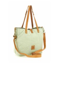 Bolsa de lona color verde claro con correas de cuero marrón, que cuenta con cierre superior de cremallera, detalle de cuero con tachuelas y correa de hombro desmontable.