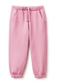 Růžové bavlněné tepláky s elastickým pasem, stahovací šňůrkou, bočními kapsami a úzkými manžetami na kotnících. Hladký povrch.