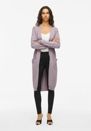 Light purple cardigan with open front, long sleeves, side pockets, and ribbed cuffs, paired with black leggings and sandals.