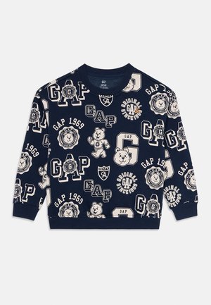 Sweat à capuche bleu marine avec des logos GAP beiges sur l'ensemble, des badges vintage et des illustrations de ours en cartoon, manches longues, poignets et ourlet côtelés.