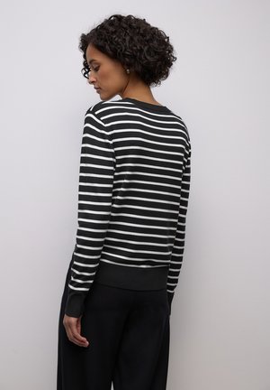 Black and white striped sweater with a round neckline, long sleeves, and ribbed cuffs, displayed from the back. Soft fabric texture.