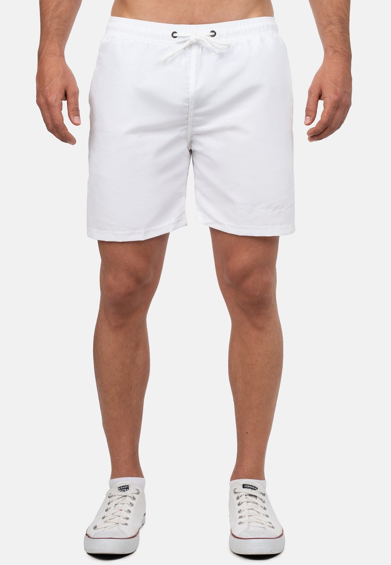 Pantaloni da bagno bianchi con vita elastica, cordino e un piccolo logo sulla gamba sinistra. Realizzati in materiale leggero e a asciugatura rapida.