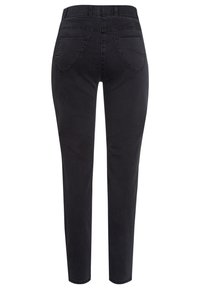 Jean noir taille haute slim avec poches arrière et passants de ceinture, vu de dos sur fond blanc.