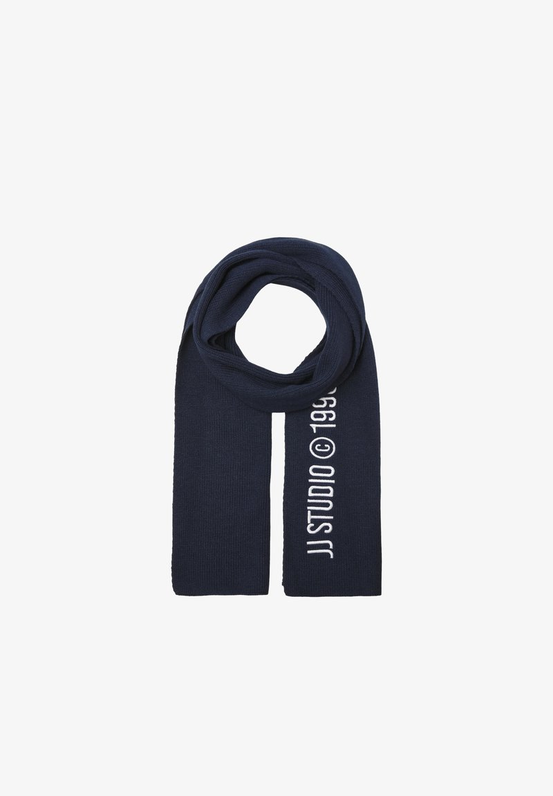Navy blue knit scarf featuring "JJ STUDIO © 1996" in white text, with a soft texture and elongated rectangular shape.
