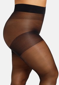 Collant neri trasparenti con un bordo opaco nero in vita, caratterizzati da un effetto sfumato che passa da scuro a trasparente sulle gambe. Texture liscia in tutto il prodotto.