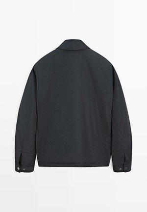 Black, lightweight jacket with a classic collar, button cuffs, and a smooth texture. Designed for a relaxed fit with a minimalist style.