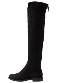 Botas negras por encima de la rodilla hechas de suave ante, con suela plana, textura lisa y detalle de cordón en la parte trasera para una apariencia ajustada.