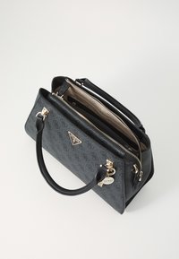 Black textured handbag with gold hardware, top zip closure, dual handles, and logo detail. Interior features a light lining and multiple pockets.