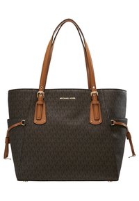 Sac cabas Michael Kors marron foncé avec anses en cuir fauve, brides latérales réglables et motif monogramme MK subtil.