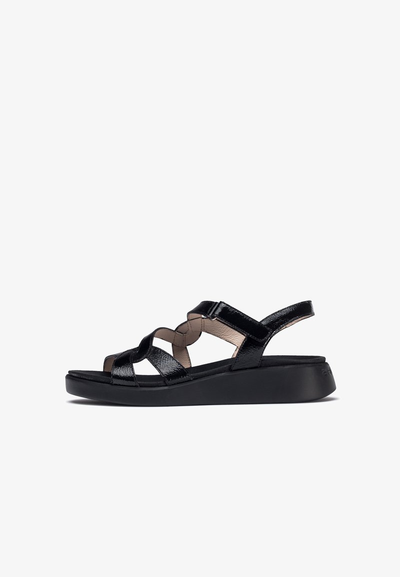 Black strappy sandals with a glossy finish, featuring crisscross straps and a cushioned footbed on a slight wedge sole.
