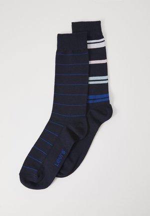 Meias azul-marinho com uma apresentando finas riscas azuis e a outra com riscas horizontais em tons pastel. Feitas de tecido macio, projetadas para conforto.