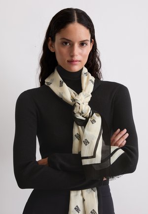 Sciarpa leggera color crema con motivo geometrico nero e bordo rifinito. Tessuto strutturato che cade elegantemente intorno al collo.