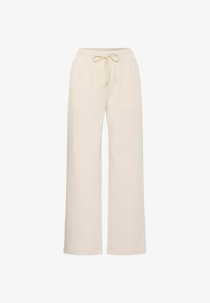 Bežid laiad püksid, mis on valmistatud pehmest kangast, millel on elastne vöökoht ja string. Omab siledat tekstuuri ja ei sisalda nähtavaid mustreid.