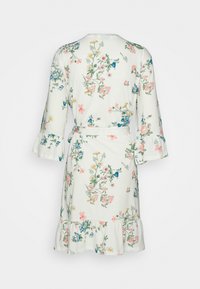 Bloemenpatroon vest in lichtcrème, met gerimpelde mouwen en zoom, een ceintuur in de taille en een zachte, gestructureerde stof.