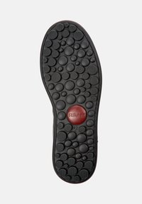 Shoe sole with black circular patterns, textured grips, and a central red circle labeled "camper" with size "42 c" below.