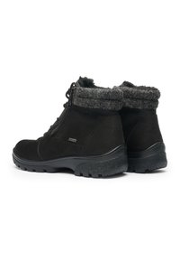 Black winter boots with thick textured rubber soles, side zipper, laces, and gray fuzzy lining around the ankle collar.
