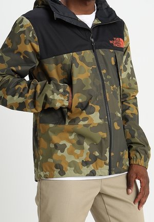 Kurtka w kamuflażu w kolorze zielonym, brązowym i czarnym, z zamkiem z przodu, regulowanym kapturem i elastycznymi mankietami. Zawiera logo na piersi.