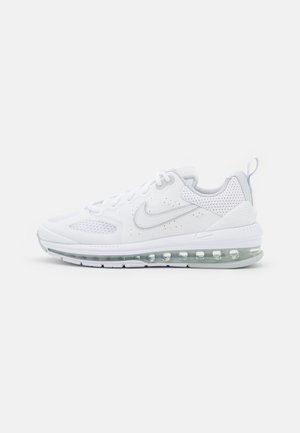 White Nike Air Max sneaker with mesh panels, perforated heel, visible air cushion sole, and lace-up closure facing right on plain background.
