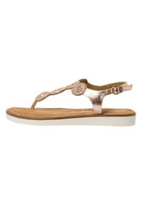 Sandal v rožnato zlati barvi z metalnim zaključkom, okrašen z dekorativnimi cvetnimi motivi, z thong obliko in nastavljivim trakom okoli gležnja; vsebuje rjavo podlago in belo podplat.