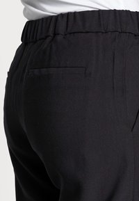 AllSaints Kalhoty - black