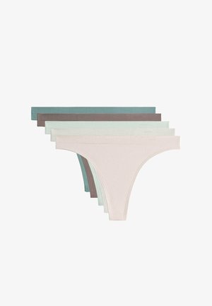 Woman wearing light green, seamless bikini-style underwear, showing waist, hips, and upper thighs against a neutral background.