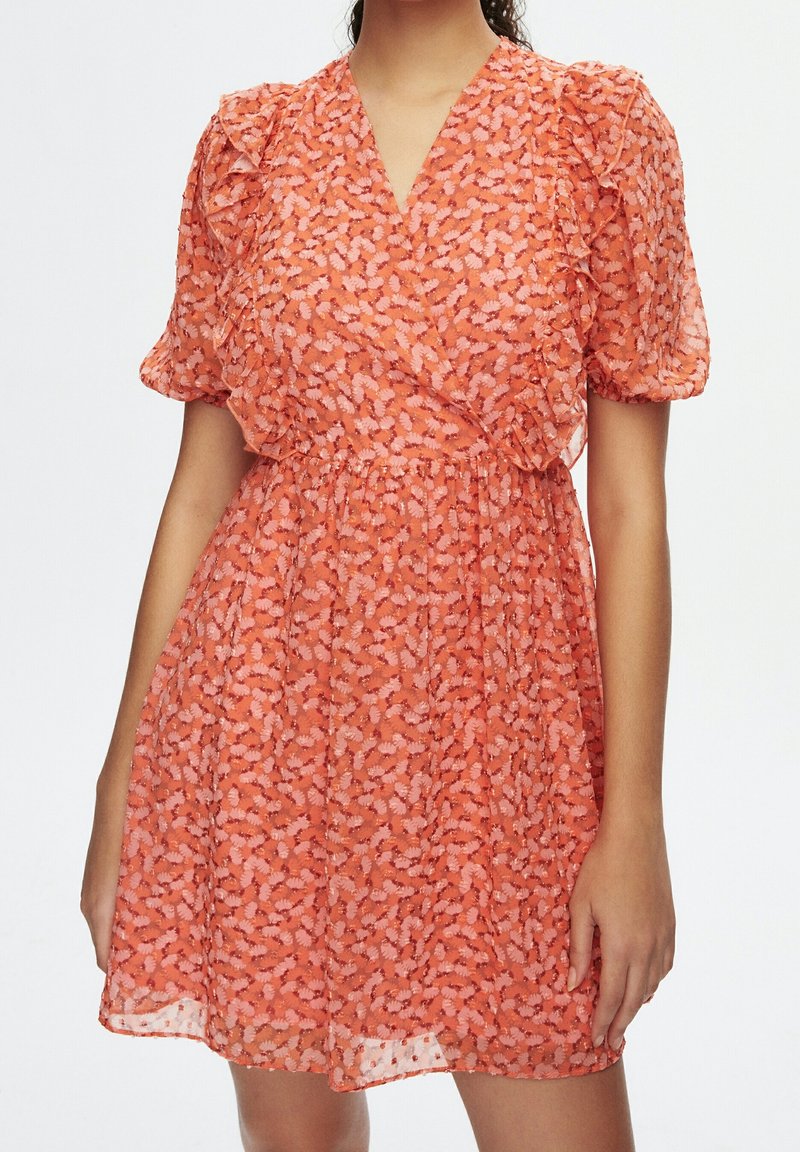 Short-sleeved orange dress with a floral pattern, gathered waist, and ruffled sleeves, made from a lightweight, sheer fabric.