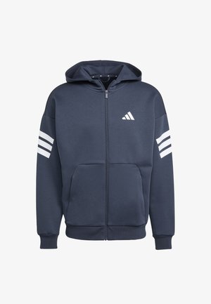 Marineblauwe hoodie met rits, gemaakt van zachte stof, voorzien van een zak aan de voorkant, geribbelde manchetten en drie witte strepen op de mouwen. Adidas-logo aanwezig.