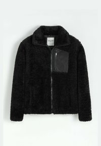 Veste en polaire noire zippée avec col montant et poche poitrine zippée avec un panneau en tissu lisse.